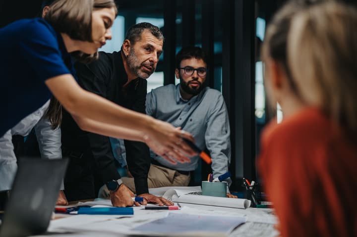 A diverse group of business people collaborating and brainstorming on a project in the office