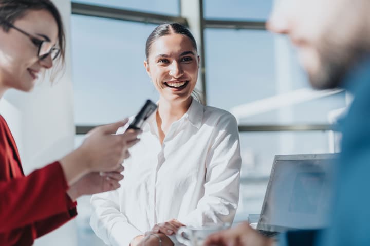 Business colleagues casually meeting in a bright office environment