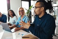 Young African American businessman discussing work in the office