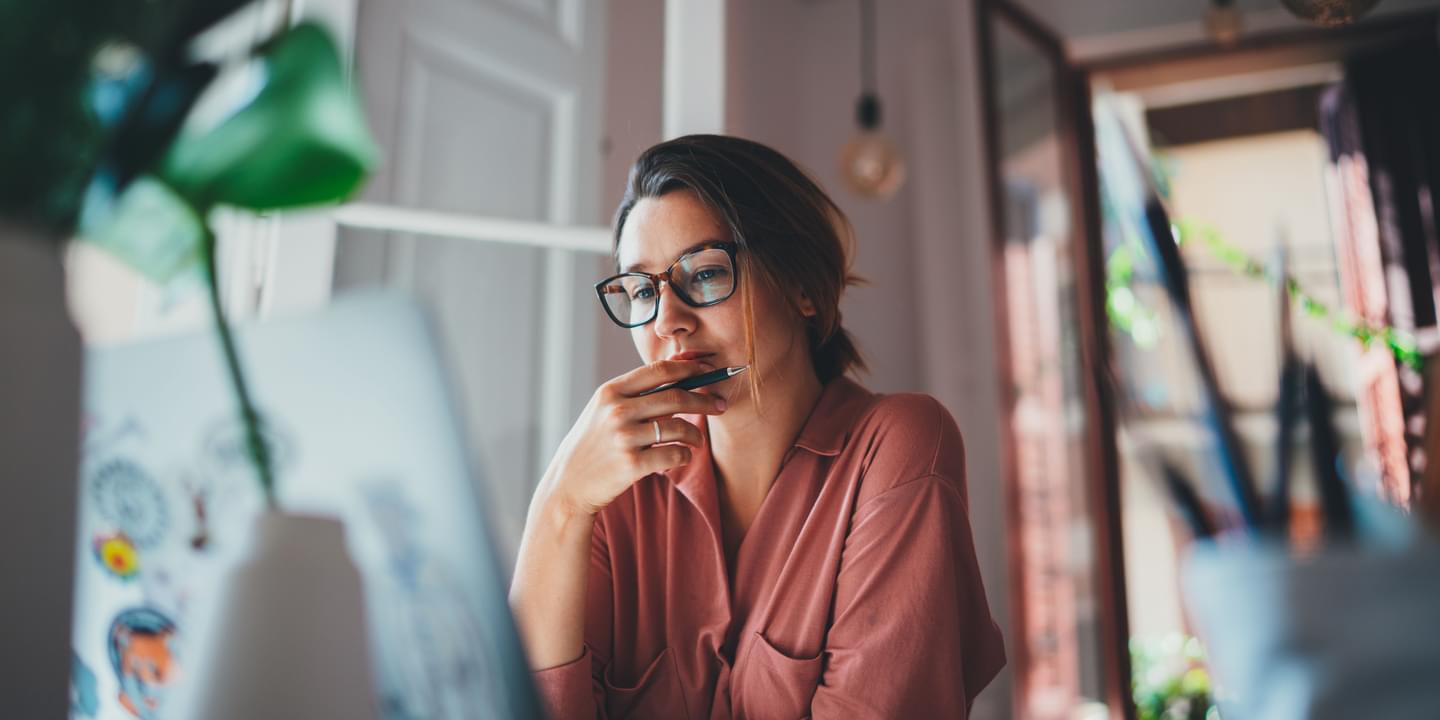 Woman Working From Home Looking At Computer