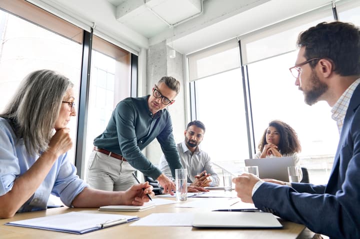 Group of business people in a conference room discussing strategic planning.
