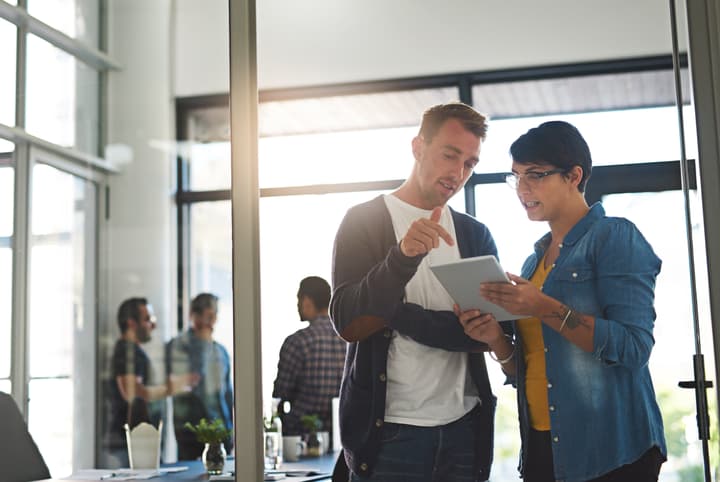 Shot of a two colleagues having a conversation before meeting in the boardroom.
