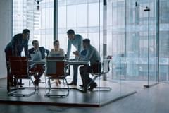 Group of business people working with technology at a meeting in a conference room
