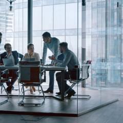 Group of business people working with technology at a meeting in a conference room