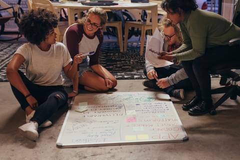 Collaboration people sitting on floor working