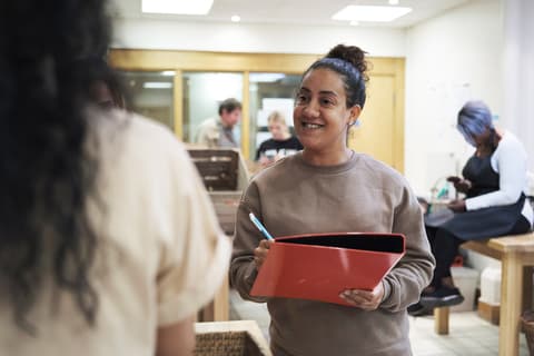 Uplift community service woman of color with binder